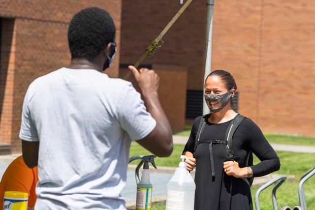 person talking while wearing a see-through face mask.