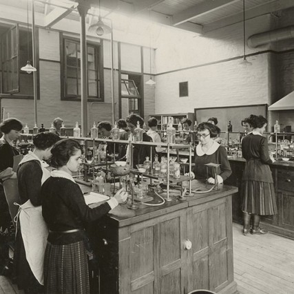 students working in a science lab around 1900-1920.