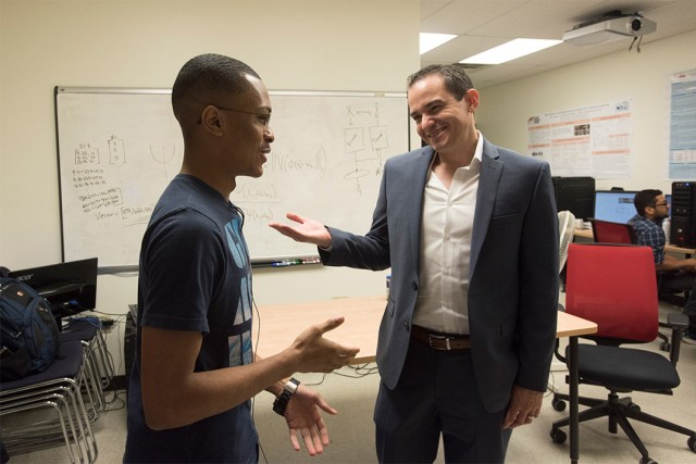 professor talking with student in a lab.