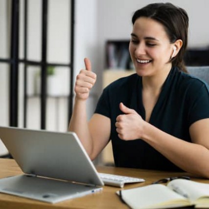 person giving a thumbs-up in a virtual meeting.