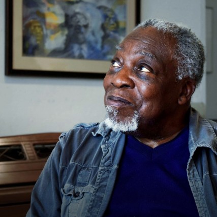 A portrait of Luvon Sheppard looking off into the distance.