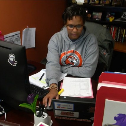 athletics director working at her desk.