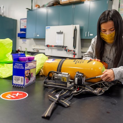 student works on project with an air tank.