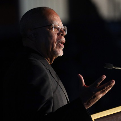 man speaking at podium.