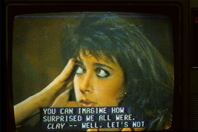 TV in the 1980s showing a woman's face and closed captioning that reads: you can imagine how surprised we all were.