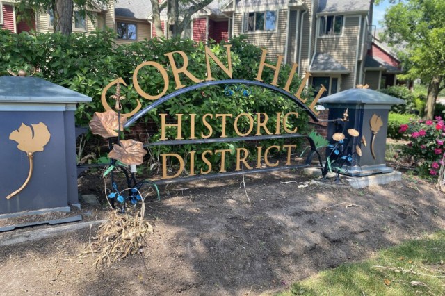 sign in front of neighborhood that reads: Corn Hill Historic District.