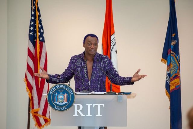 man speaking at podium.