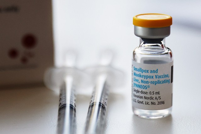 two syringes and a small glass vial of smallpox and moneypox vaccine.