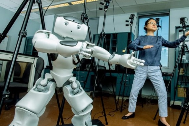 Robot and woman doing tai chi