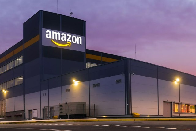 exterior view at dusk of an Amazon distribution center building.