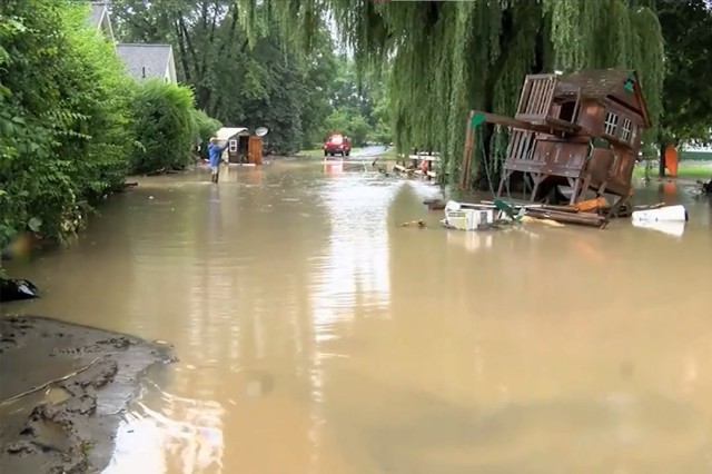 a heavily flooded area with a wooden playset partially submerged.