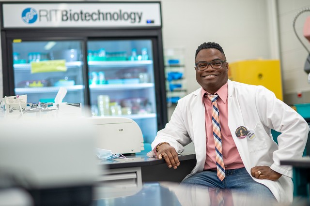 researcher posing in a biotechnology lab.