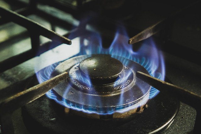 close up of the blue flame of a gas burner on a stove.