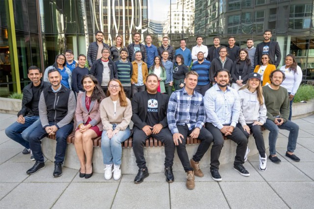 large group of people posing outside for a photo.
