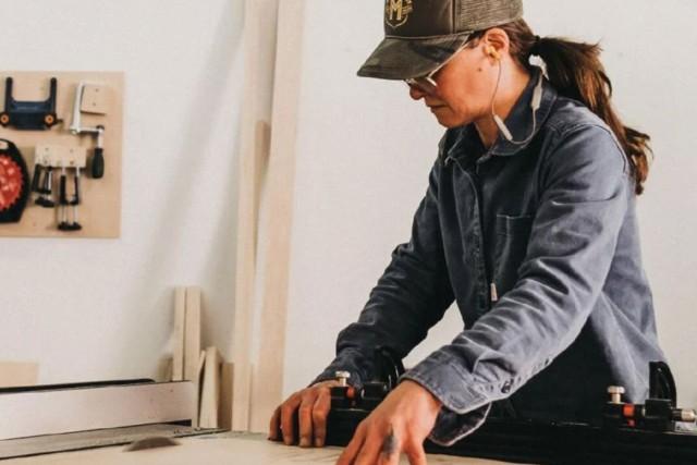 woodworker lining up a cut on a table saw.