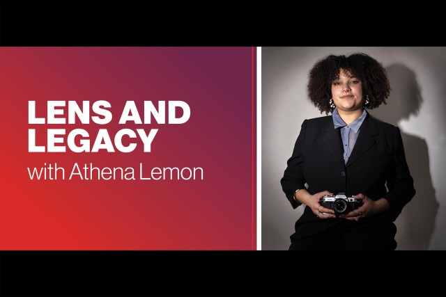 Athena Lemon stands for a portrait while holding a camera.