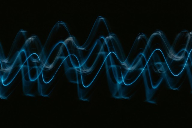 a soundwave is shown in blue on a black background.