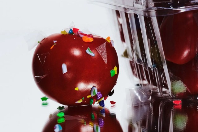 a tomato is shown covered in microplastics
