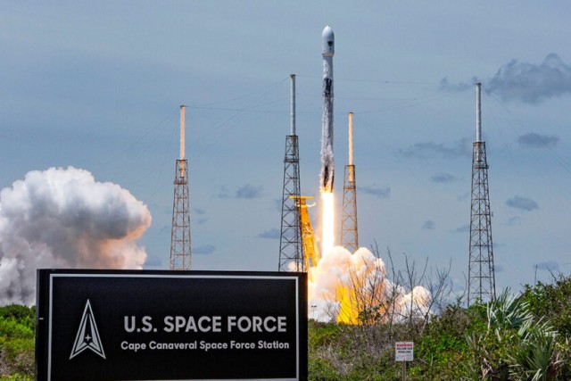 Rocket taking off. Sign in front of rocket reads, U.S. Space Force Cape Canaveral Space Force Station