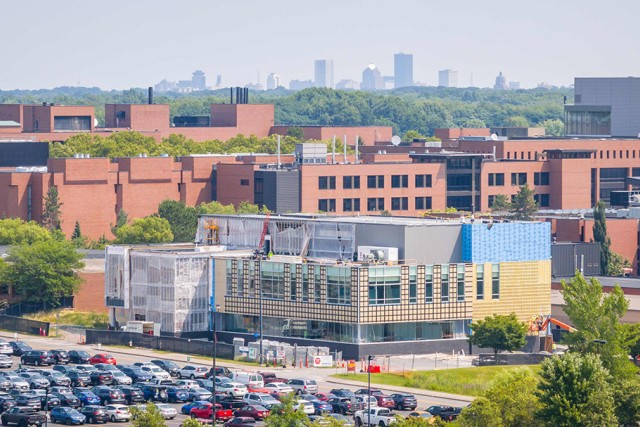 R I T new research building appears on campus with the city of Rochester New York in the background.