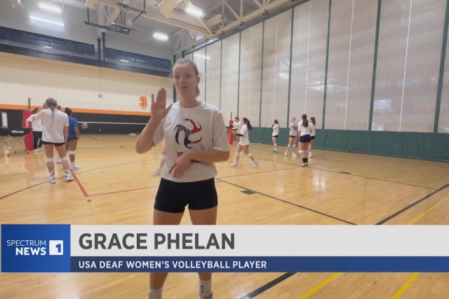 Grace Phelan is shown on a volleyball court.