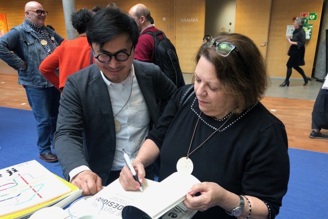 Lorraine Justice signs a copy of her 2019 book The Future of Design.