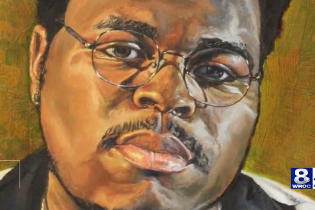 A detailed painting of a man with glasses, a mustache, and a goatee, gazing intently. The artwork uses warm tones and textured brushstrokes, giving it a lifelike quality. A news station logo appears in the bottom right corner.