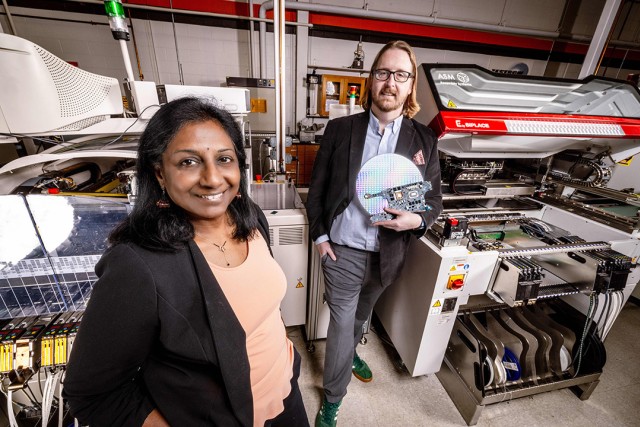 two people stand in a mechanical engineering lab.