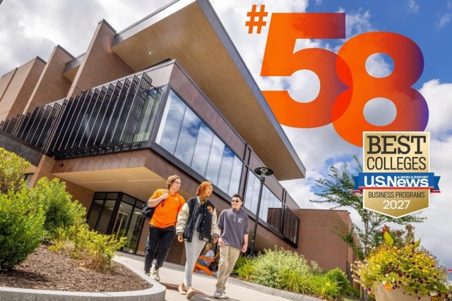 Three business students walking outside the new building expansion at Saunders College of Business