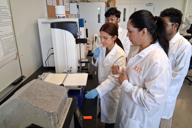 From left, Ayyuce Guzide Teke, Balaveera Srinivasaguru, and Victor Immanuel, students in the Food Packaging Lab, developed new barrier materials made of starch to protect paperboard packaging with Assistant Professor Sneh Bangar (foreground). 