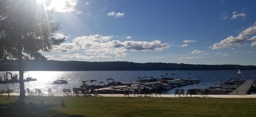 Lake photo with blue sky and boats in the water