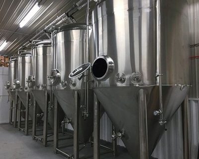 silver tanks inside brewery