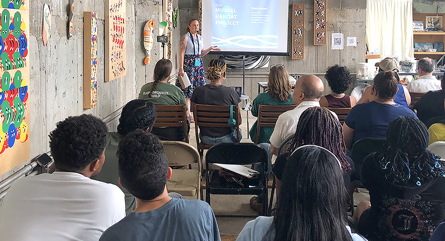 room full of people during a presentation of the mussel habitat project