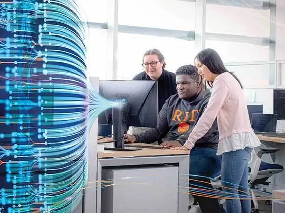 Students sit around a desktop computer looking at the screen. The left of the photo is dark with overlayed blue graphic lines that look like fiber optic wires.