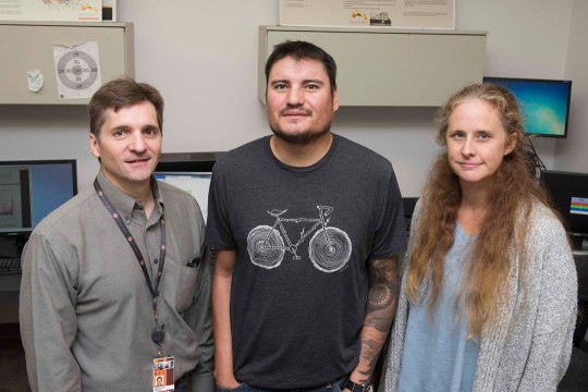 Three researchers standing