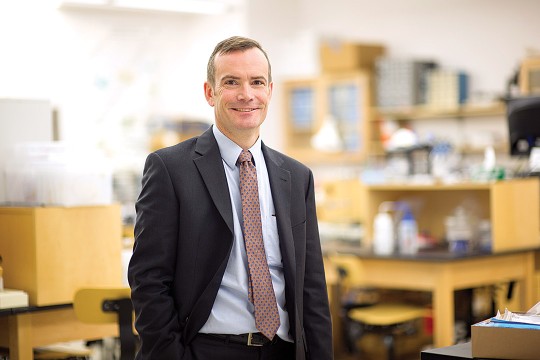 reseacher posing in lab.