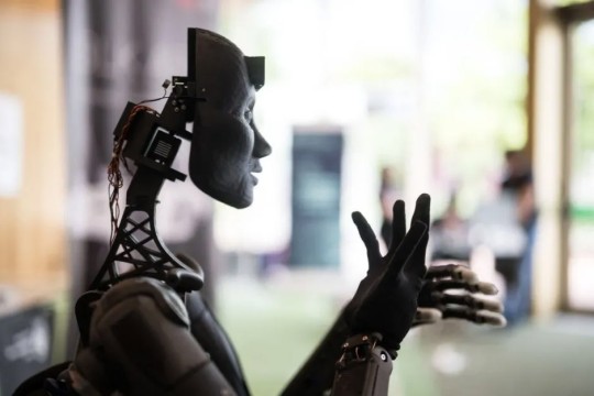 profile of an A I robot moving its hands