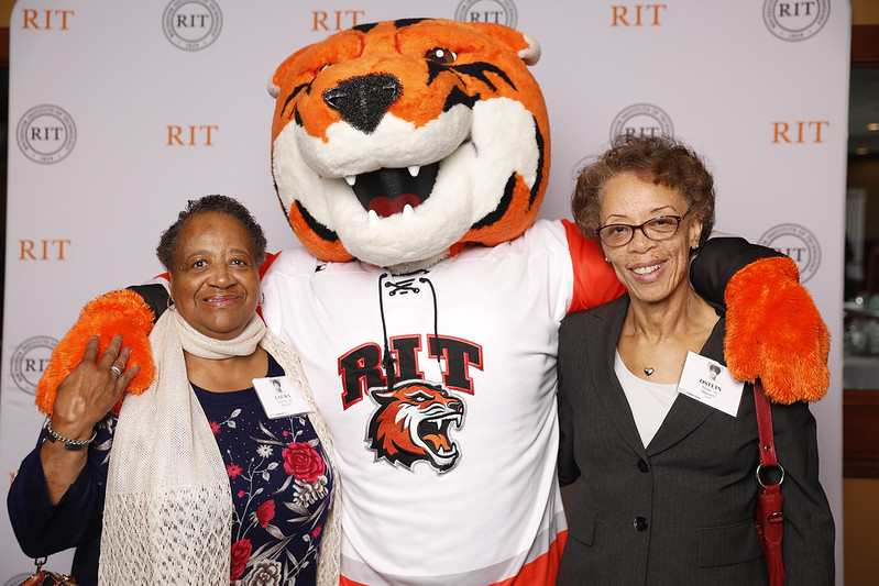 people posing with RIT mascot RITCHIE