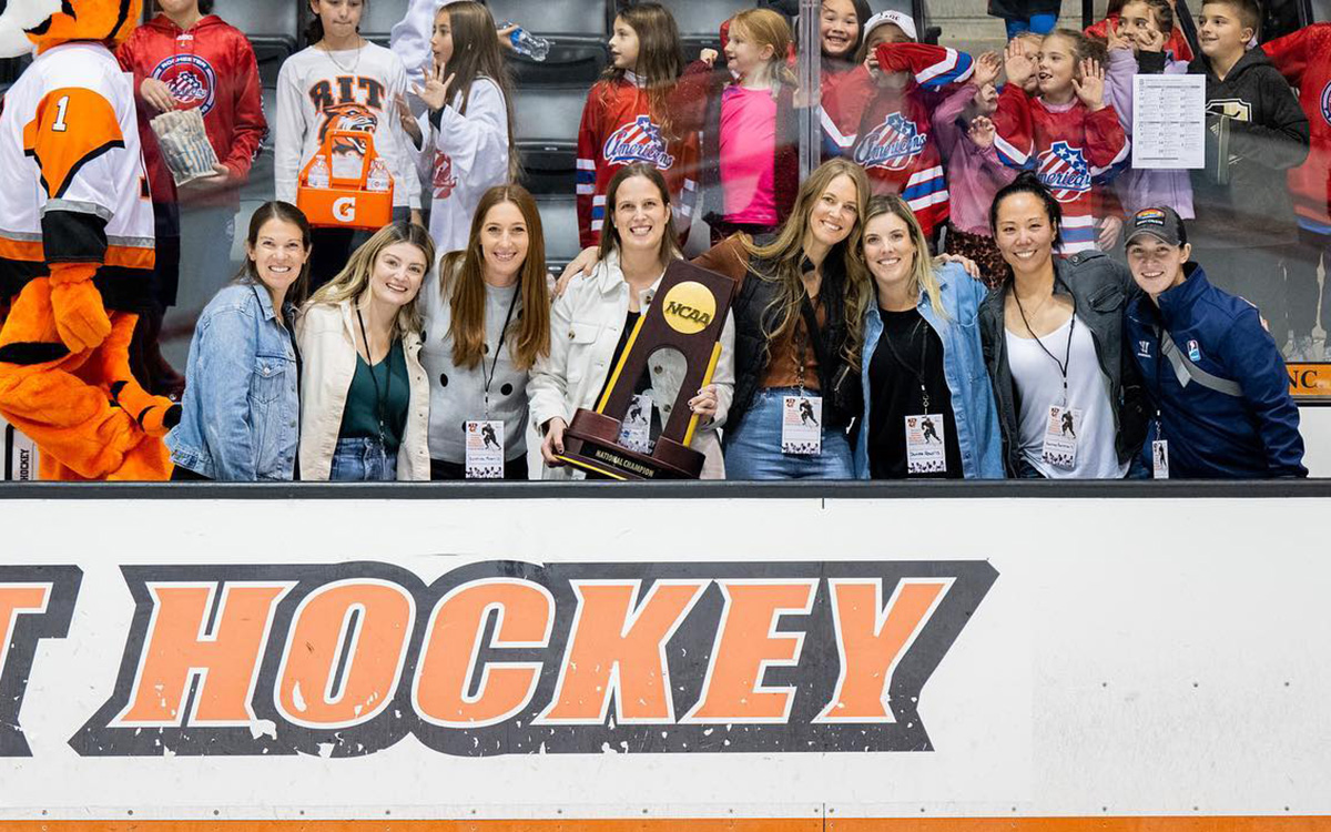 A group of women with a trophy