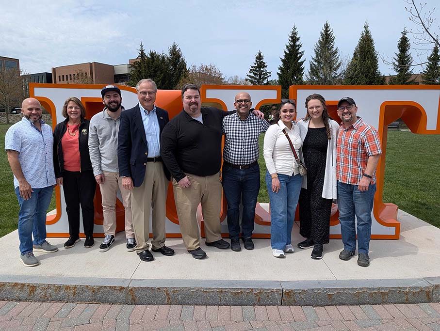 Alumni council members by RIT sign