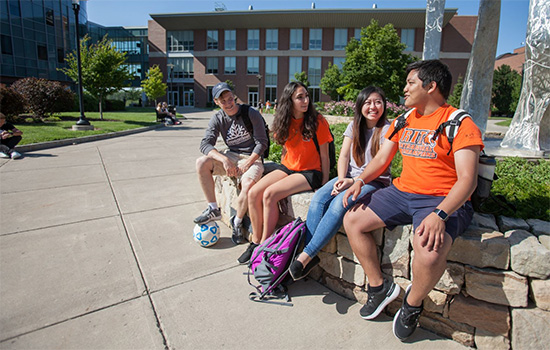 Students sitting outside on the RIT campus.