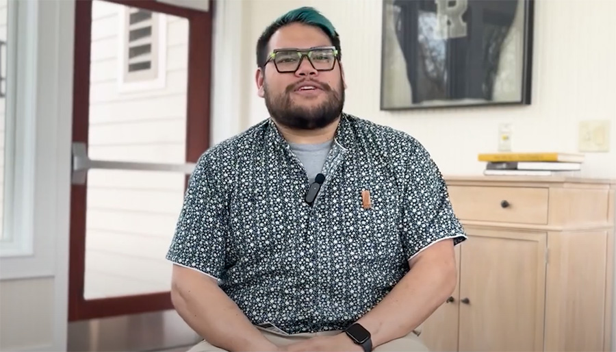 An alumnus speaking to the camera.