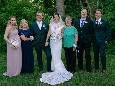 group of seven people posing for the camera at a wedding