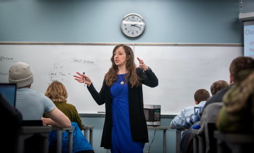 a photo of a woman instructing a room of students
