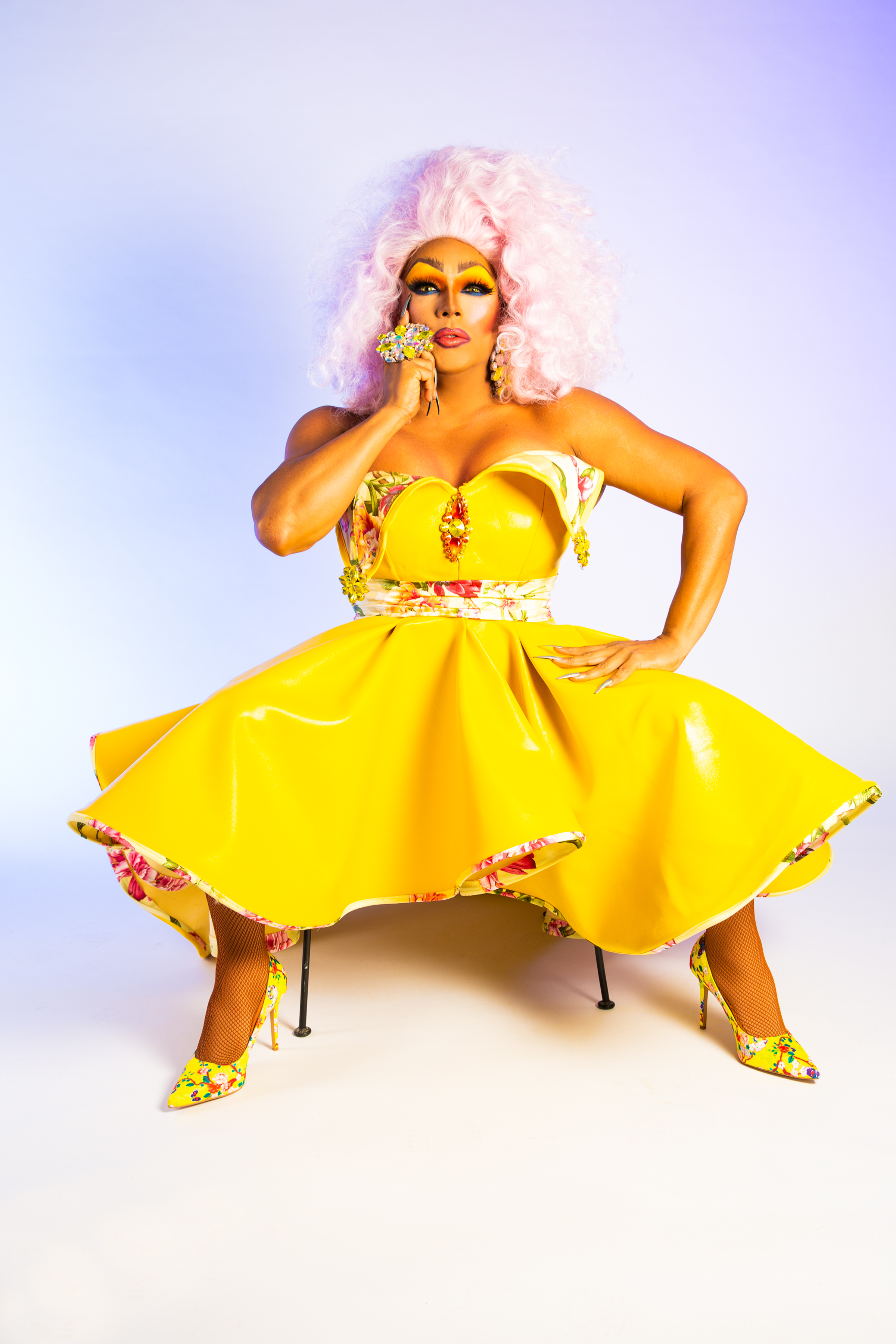 Samantha Vega in a yellow dress with a cotton candy pink wig.