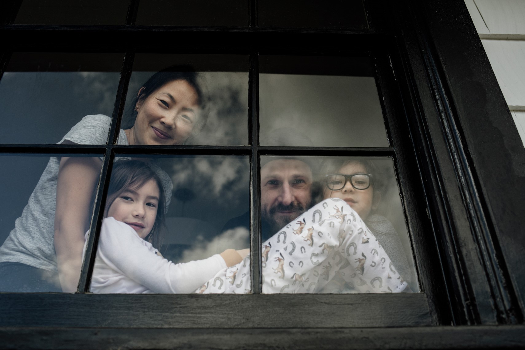 Family photographed through window