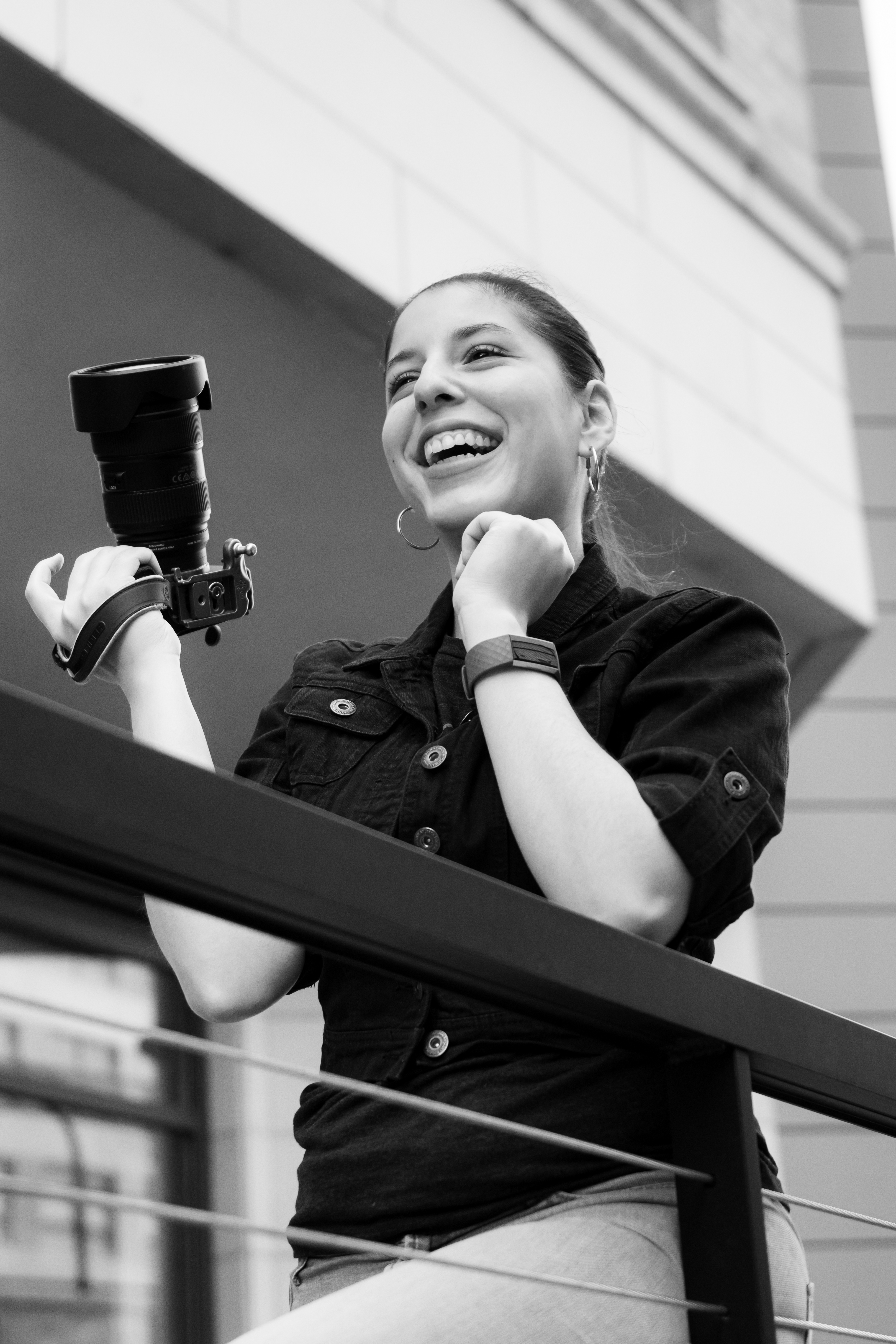 a photo of a woman holding a camera and laughing