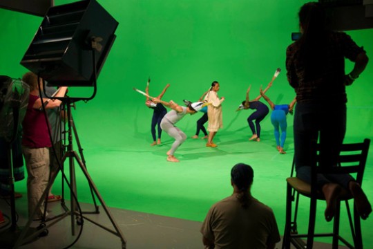 people dancing on a green-screen stage.