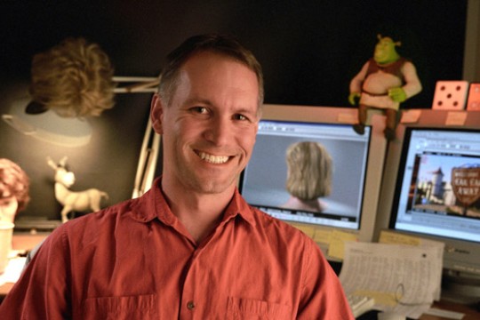 man in front of computer screens.