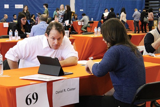 People looking at screen at event